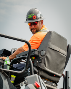 Operating Engineer sitting on a machine looking over his shoulder to the camera