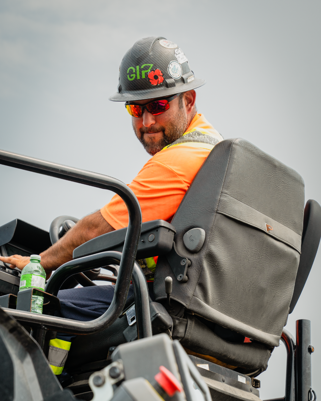 Operating Engineer sitting on a machine looking over his shoulder to the camera