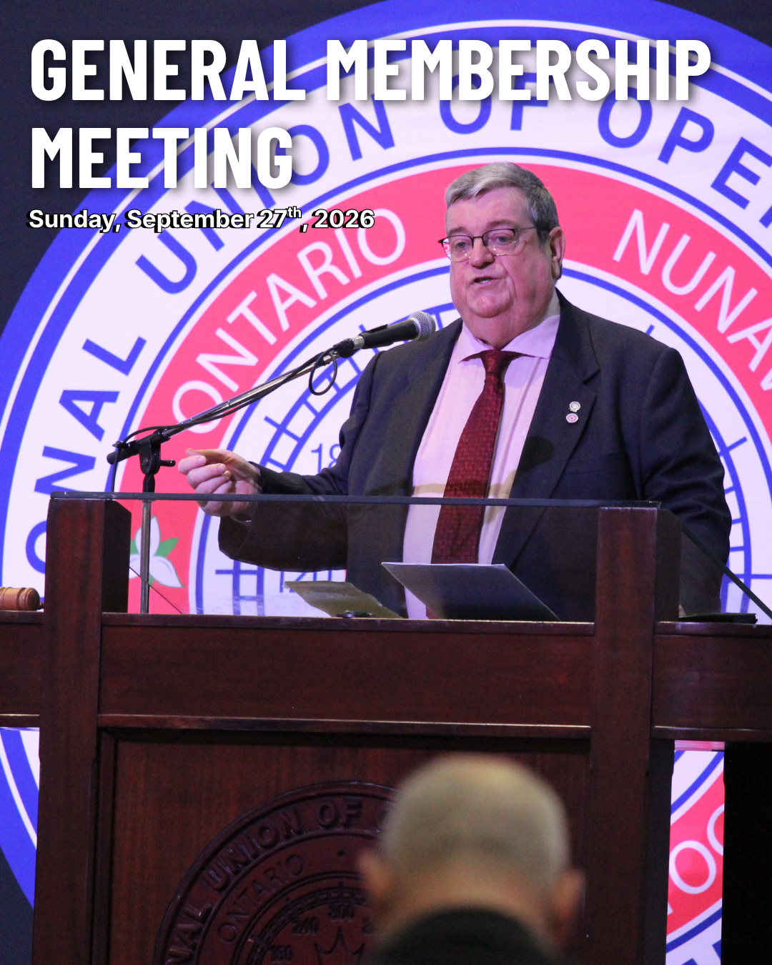 793 Business Manager Mike Gallagher standing at a podium giving a speech
