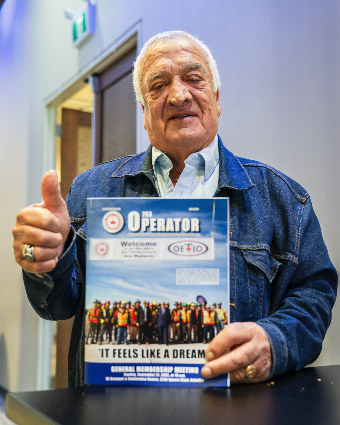Retired 793 member holding the Fall 2026 Operator magazine and giving a thumbs up