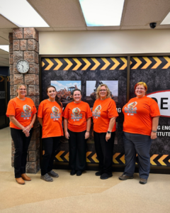 OETIO staff wearing orange shirts