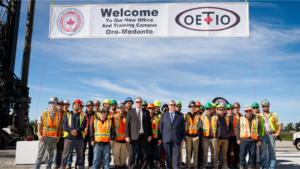 Dave Turple and Mike Gallagher stand with apprentices in front of a banner which reads:
