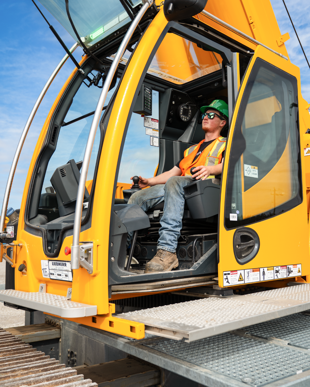 An apprentice sitting in a mobile crane.