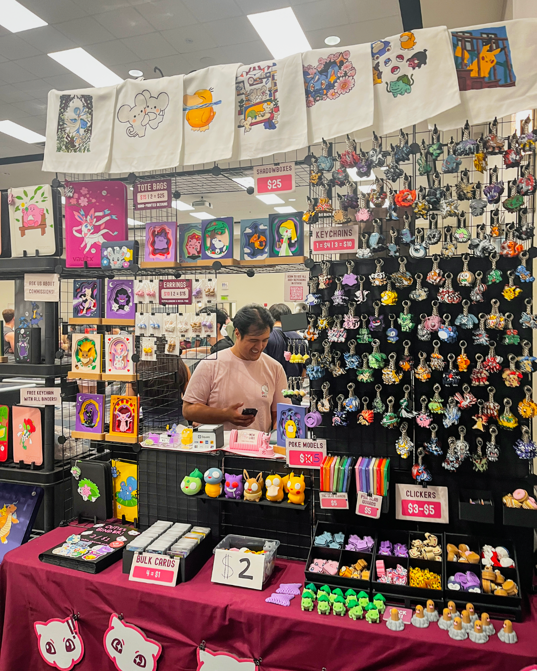 A vendor with a shop featuring key chains, art work and small knick knacks
