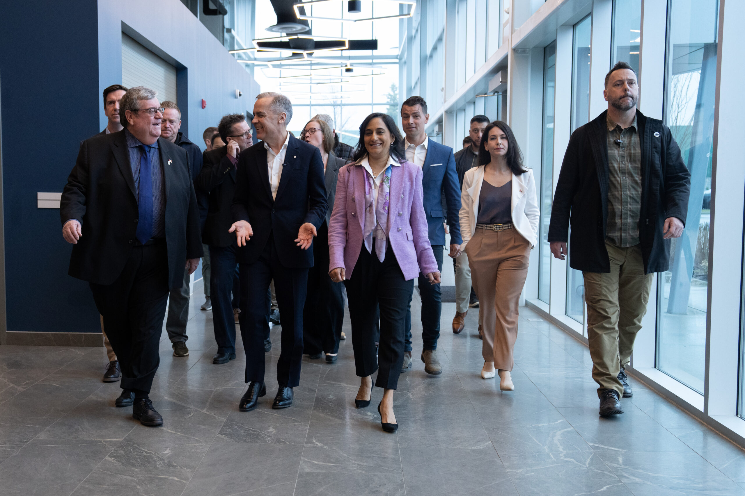 Prime Minister Mark Carney Walking with Business Manager Mike Gallagher.