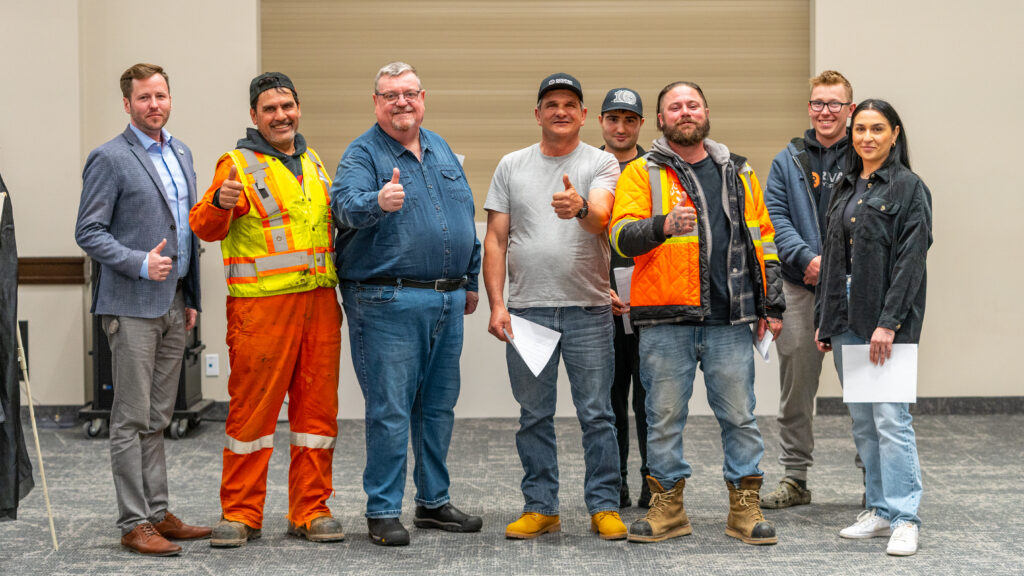 IUOE Local 793 Toronto Supervisor, Justin O'Neill; Business Manager, Mike Gallagher; and Local 793 members give a thumbs up at the Toronto District meeting in OE Banquet hall