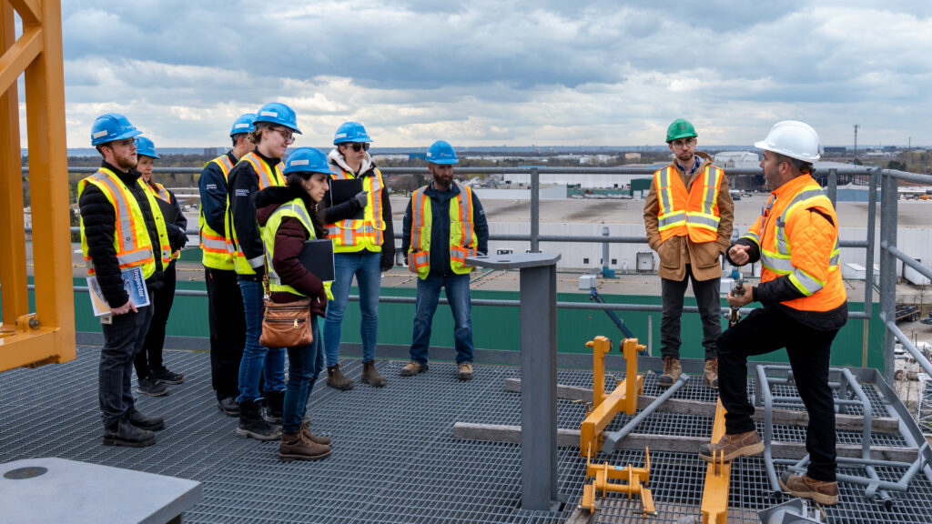 Inspectors from MLITSD listening to OETIO instructors on top of a building for Working at Heights 