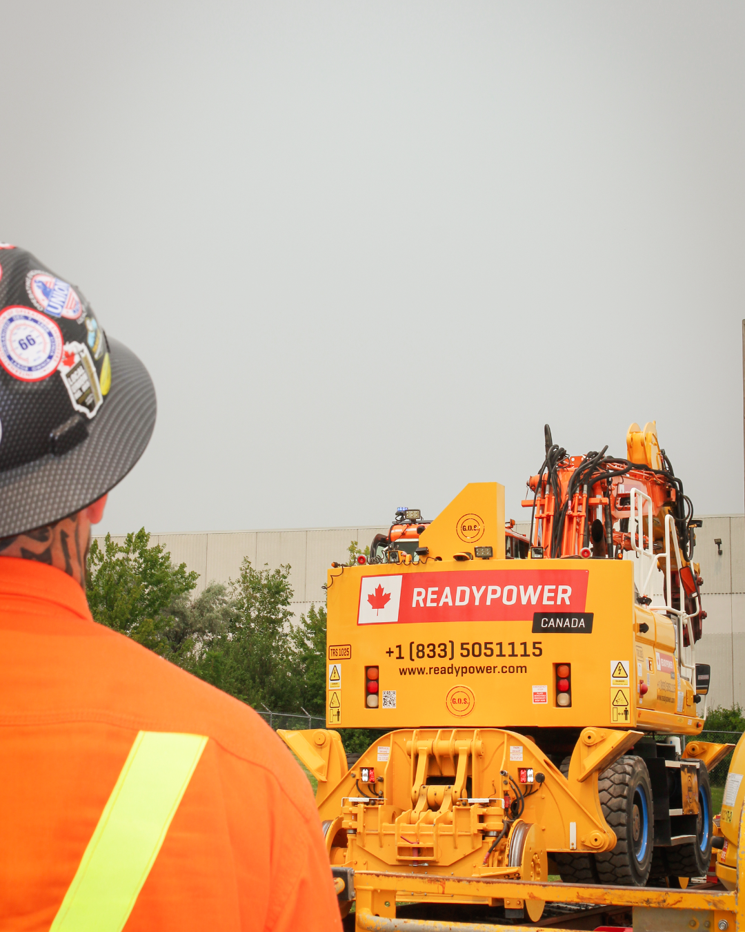 An image of the back of a High Rail Excavator, the picture is taken from over a persons shoulder