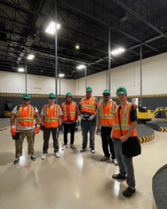 a group of pre apprentices stand together in a dimly lit room