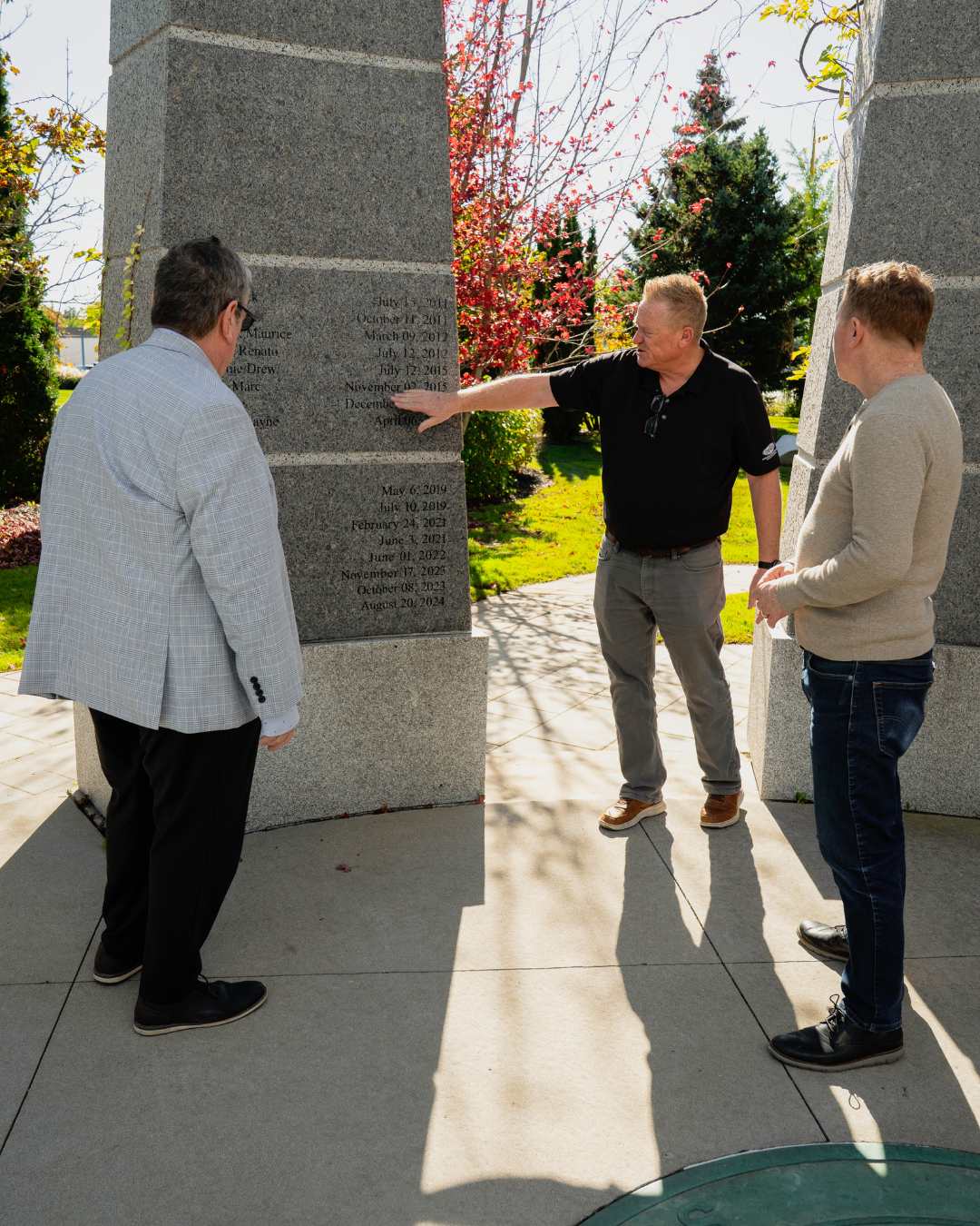 793 Business Manager Mike Gallagher (left) and 793 President Dave Turple (middle) show Sean O'Meara (right) the passed 793 members names that have been carved into our memorial garden wall