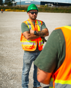 an Apprentice wearing P.P.E talking to someone just out of frame.