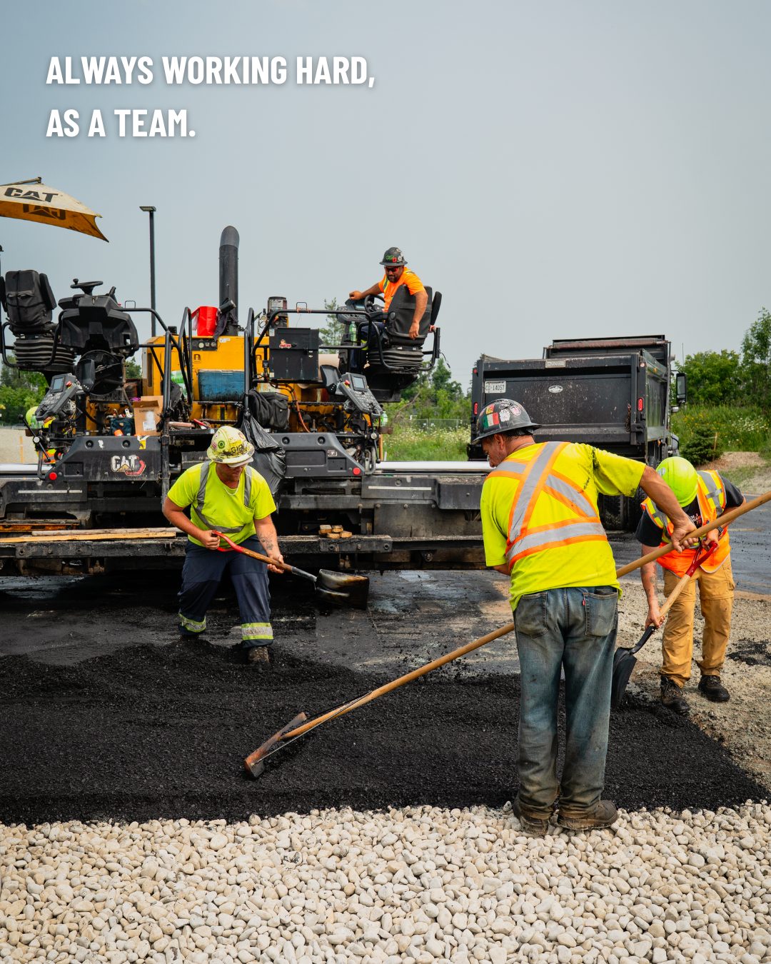 4 construction workers paving a road. Text in the top left corner of the image reads: Always working hard, as a team.