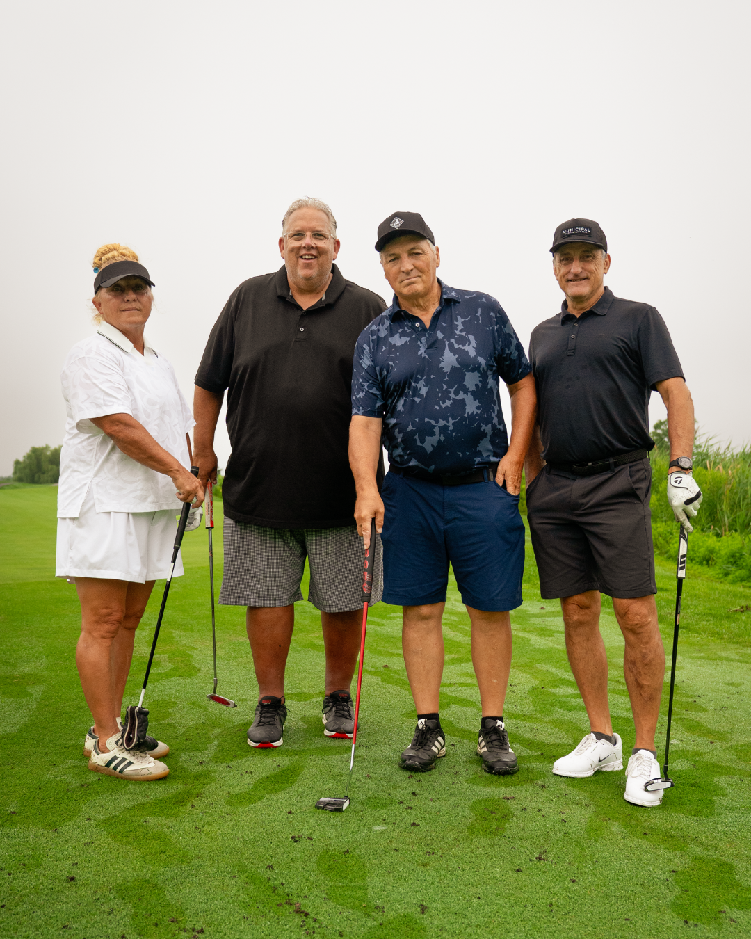 4 IUOE 793 members standing side by side on a golf course.