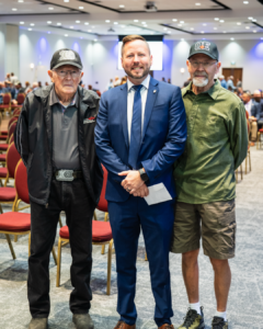 Justin O'Neill with two members at the 2026 General Membership meeting