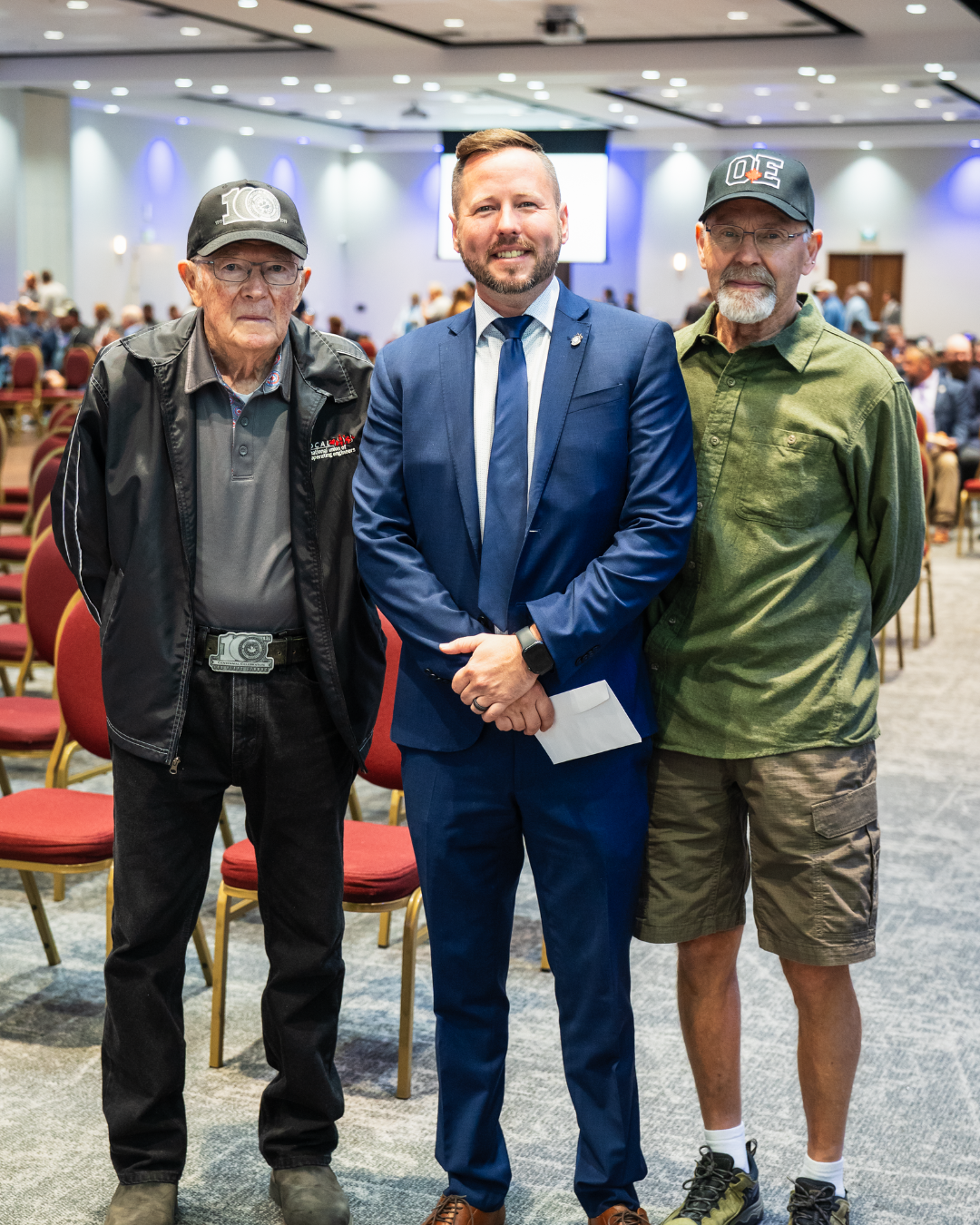 Justin O'Neill with two members at the 2026 General Membership meeting