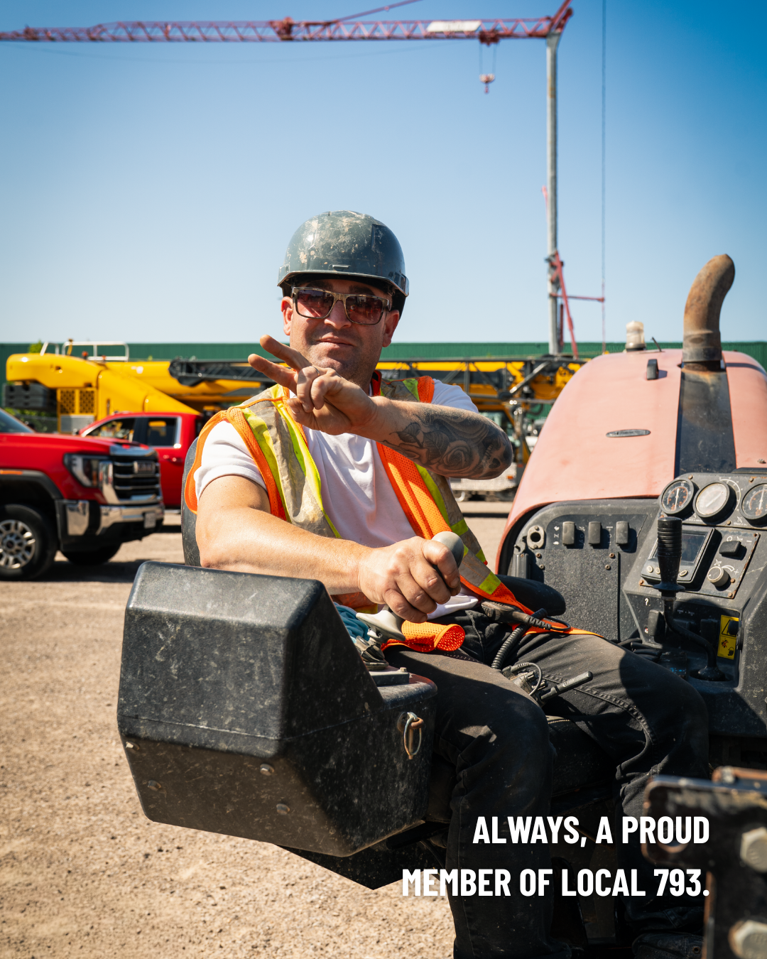 Image of a 793 member sitting in a machine giving a peace sign to the camera. Text in the bottom right corner of the image reads: Always, a proud member of Local 793.
