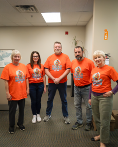 793 staff wearing orange shirts