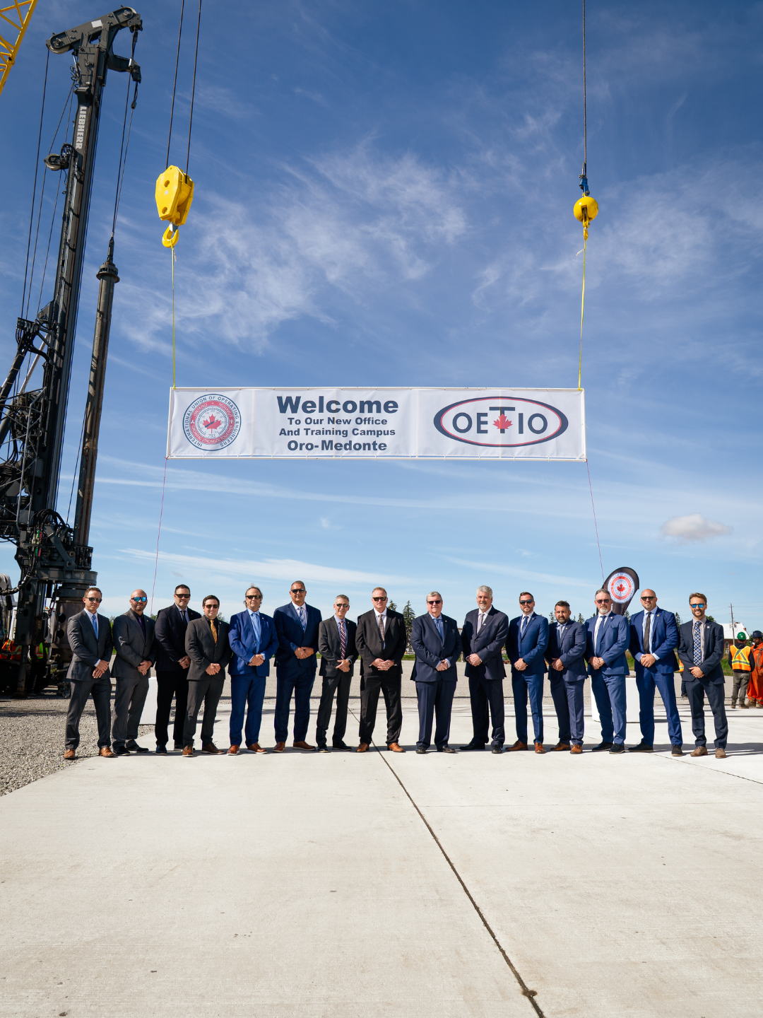 IUOE and OETIO executives and business reps stand in-front of a banner which reads: "Welcome to our New Office and Training Campus, Oro-Medonte" with the OETIO and IUOE Local 793 logo's on either side.
