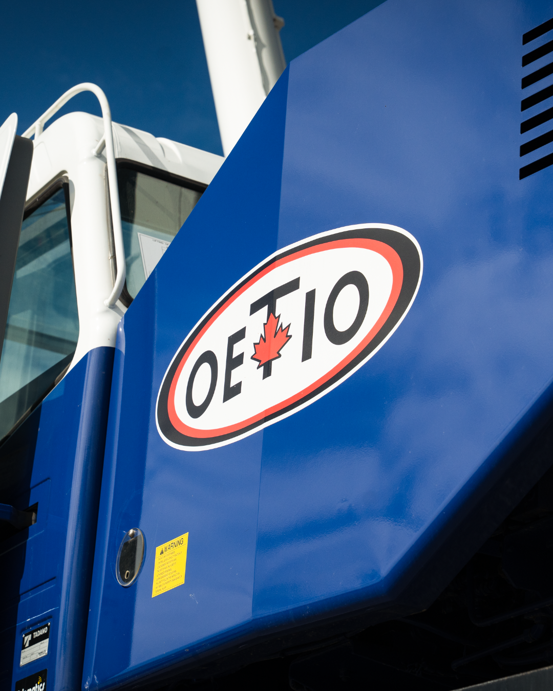 Part of a machine with the OETIO logo on it.