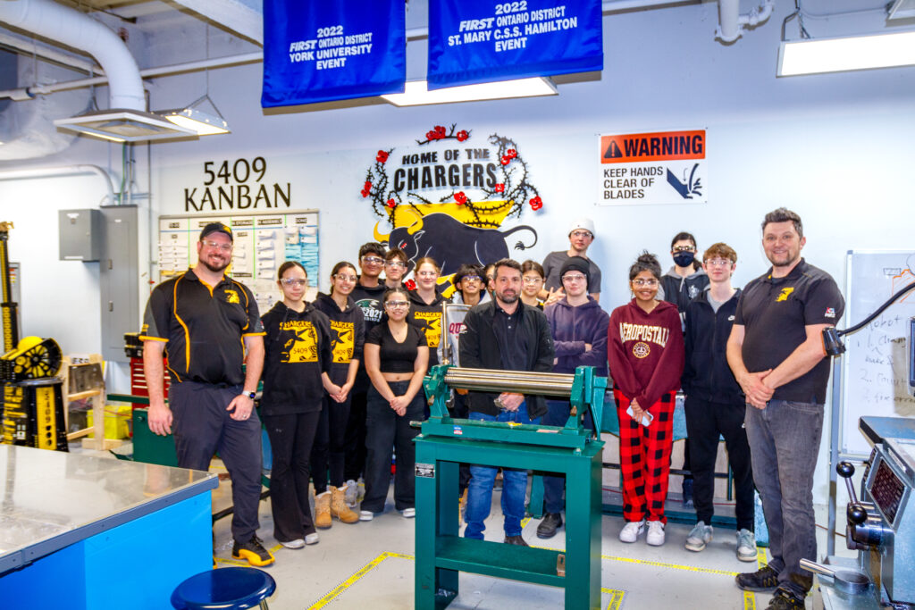 Students and staff gather in the fabrication room