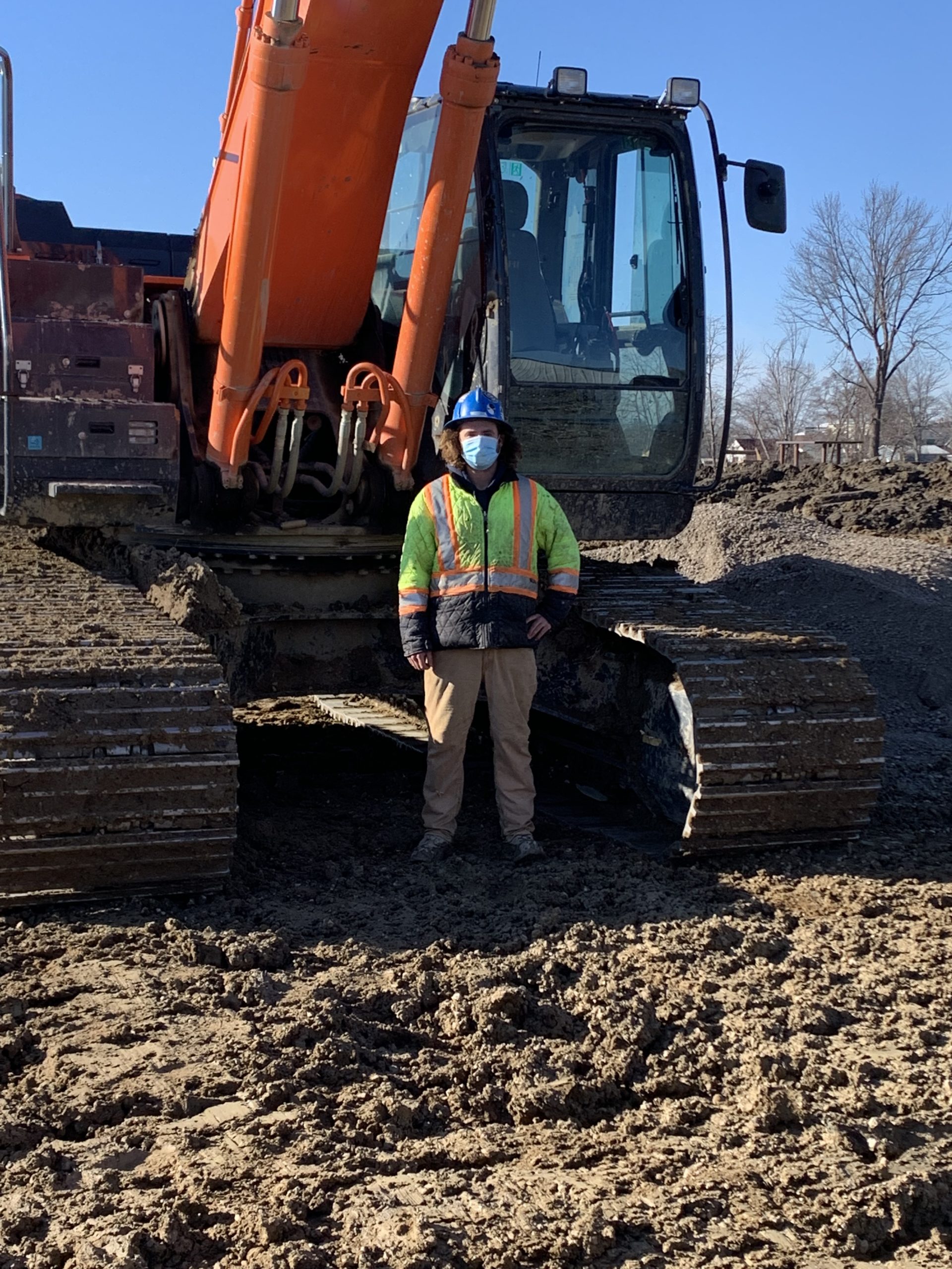 Local 793 member Josh Daley standing in front of a Hitachi 360 excavator.