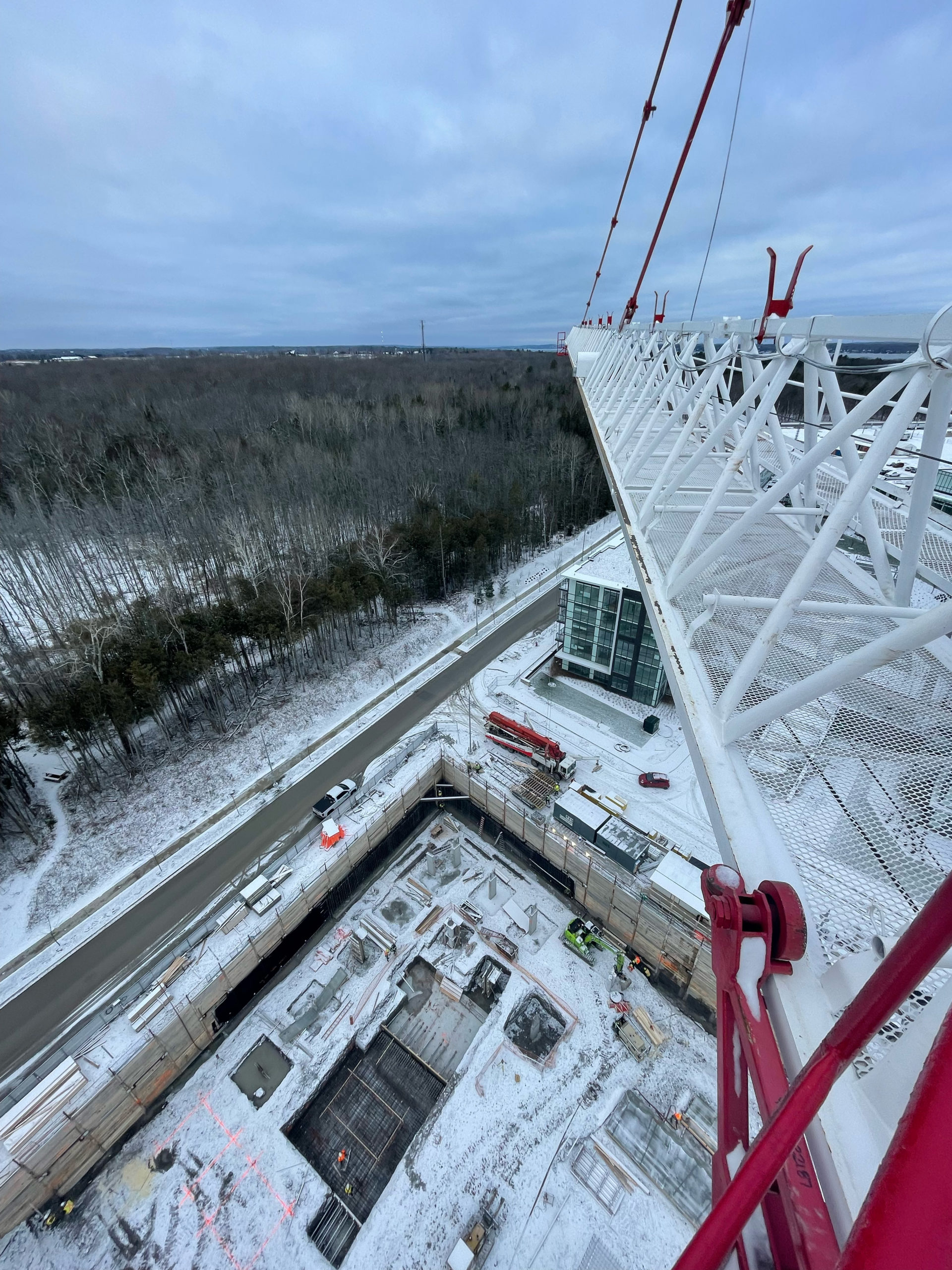 High angle shot from crane overlooking site below with snow covered grounds
