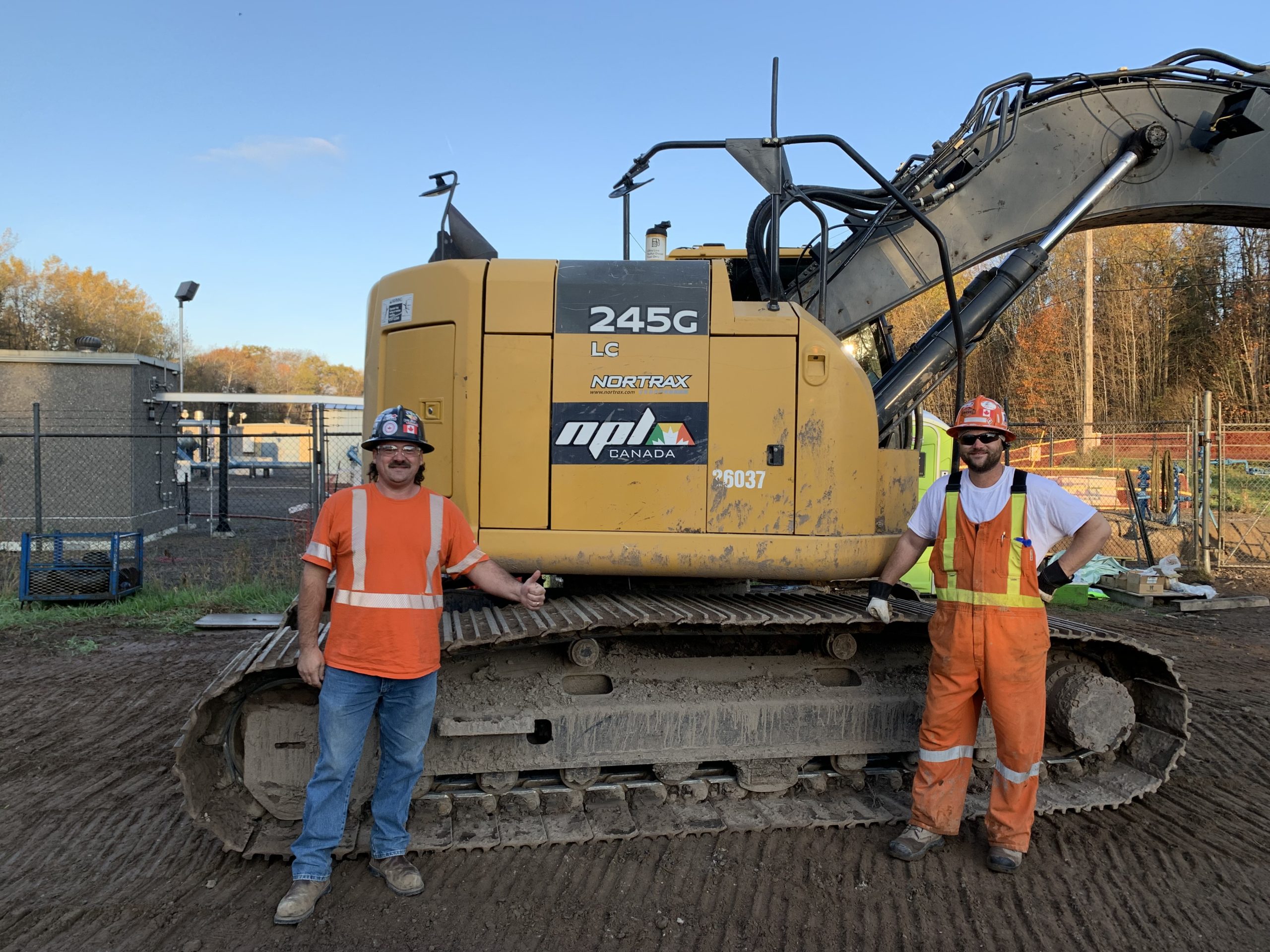 Local 793 steward Charlie Peters and oiler Dane Peters operating a John Deere 245G excavator.