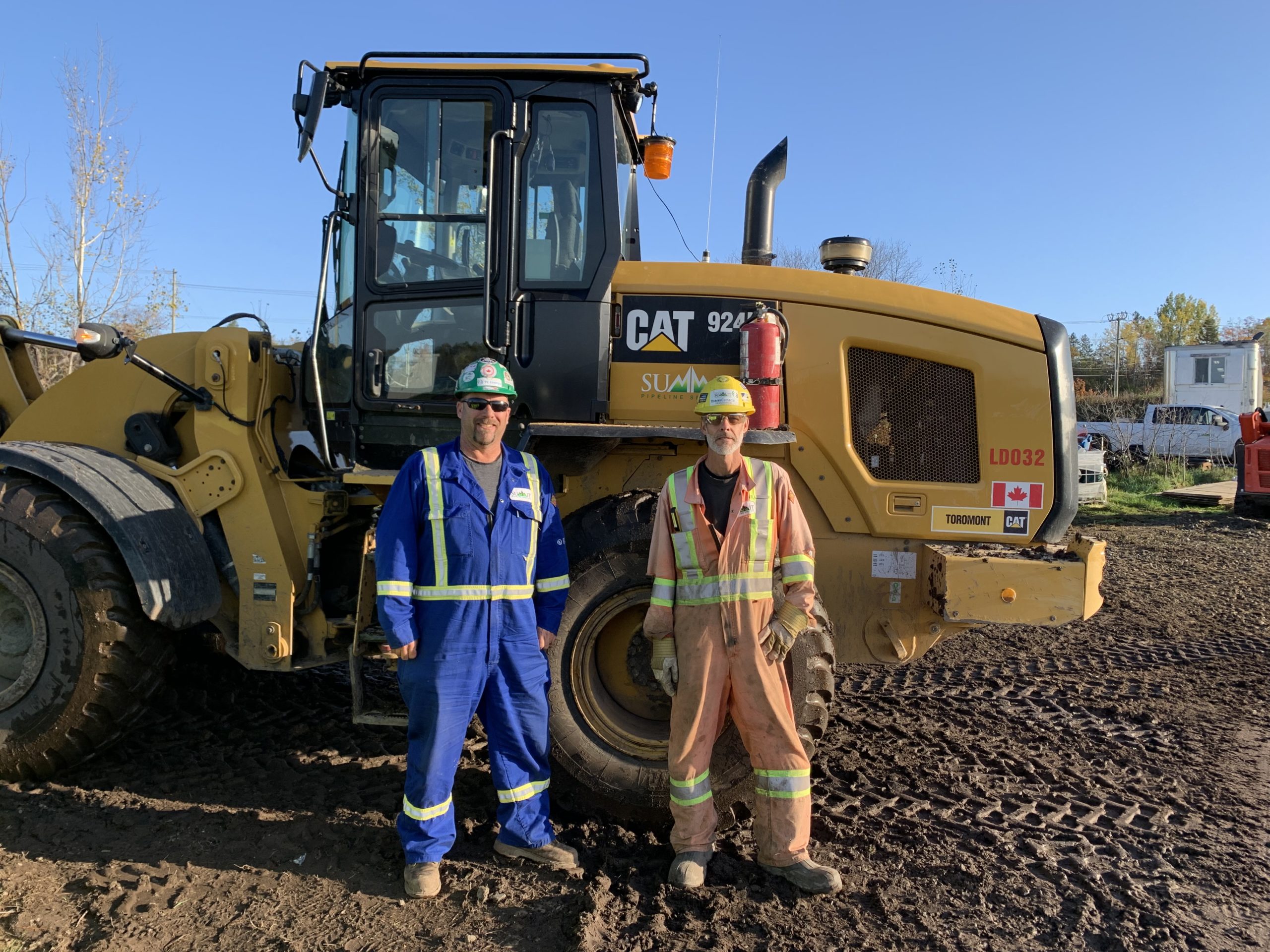 Local 793 members Dean Dobson and Chris Pettipas standing in front of a Cat 924 loader.