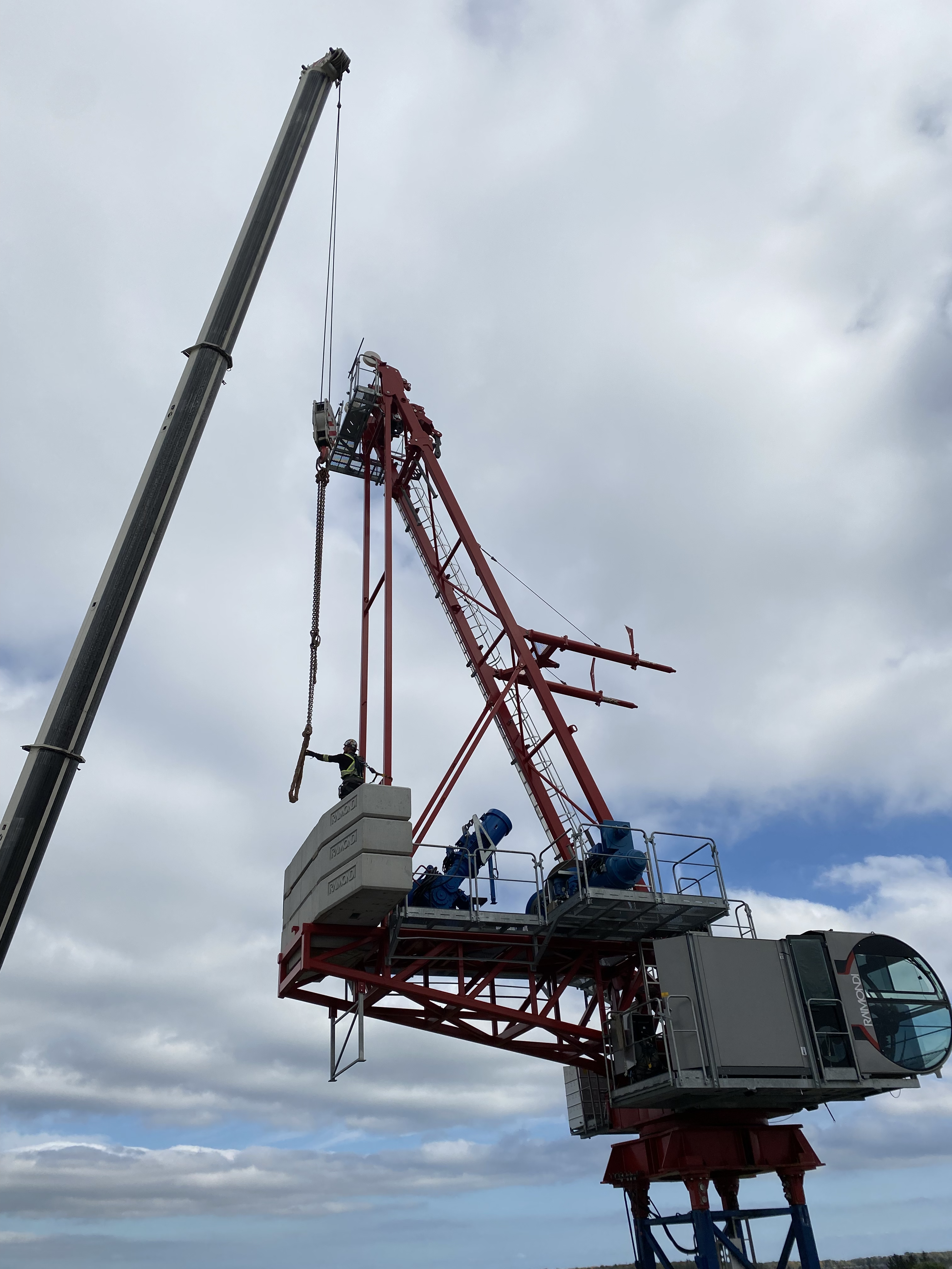 Daniel Grecco stands on the counterweight to dismantle the Raimondi LR273 tower crane.