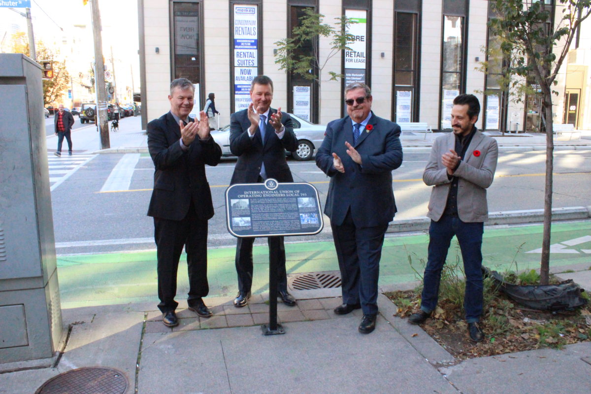 Local 793 President Joe Redshaw, IUOE Canadian Regional Director Lionel Railton, Local 793 Business Manager Mike Gallagher, and York University history professor Gilberto Fernandes applaud after unveiling the plaque.