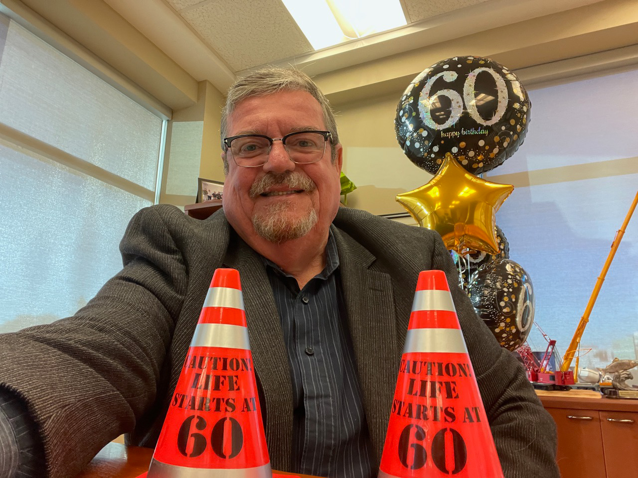 Business Manager Mike Gallagher celebrates his 60th birthday at the office.