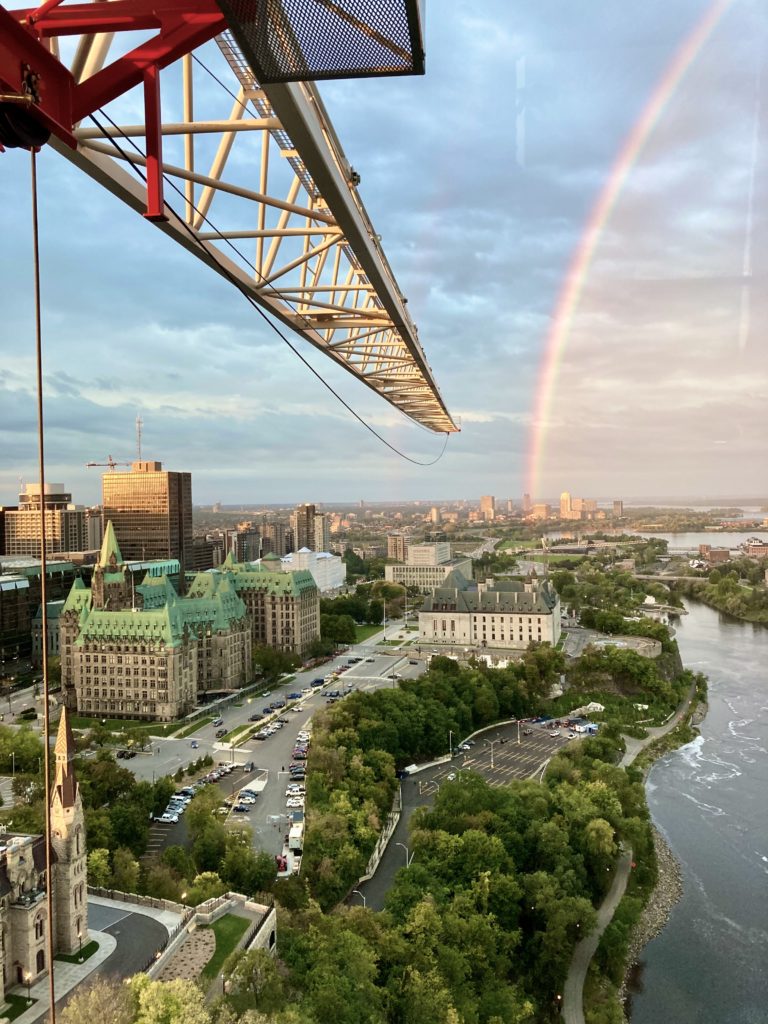 Aesthetic photo of Ottawa skyline with crane edge and a rainbow in the sky